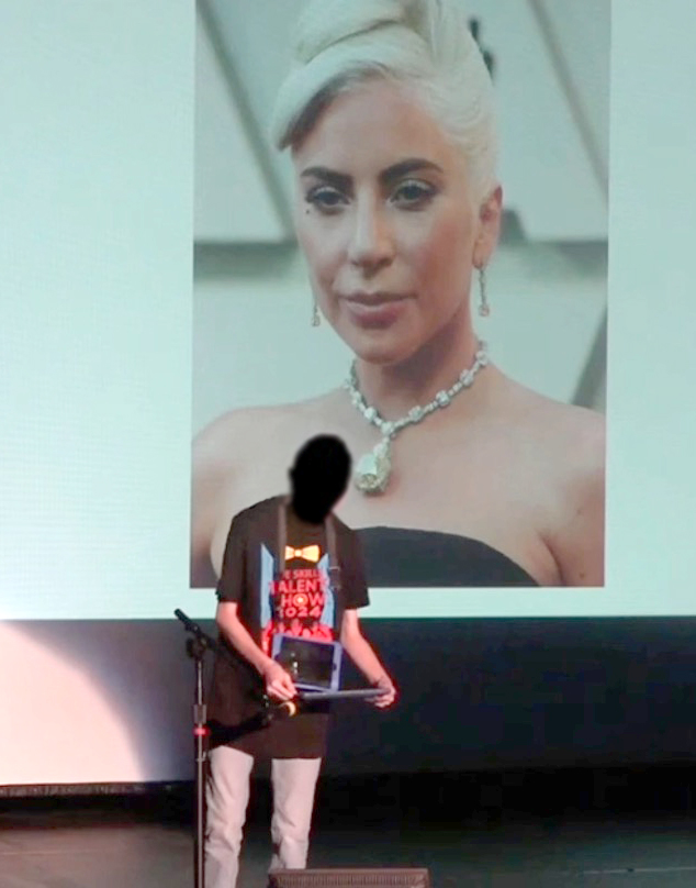 Silhouette of young man holding an iPad in front of a screen with a photo of Lady Gaga