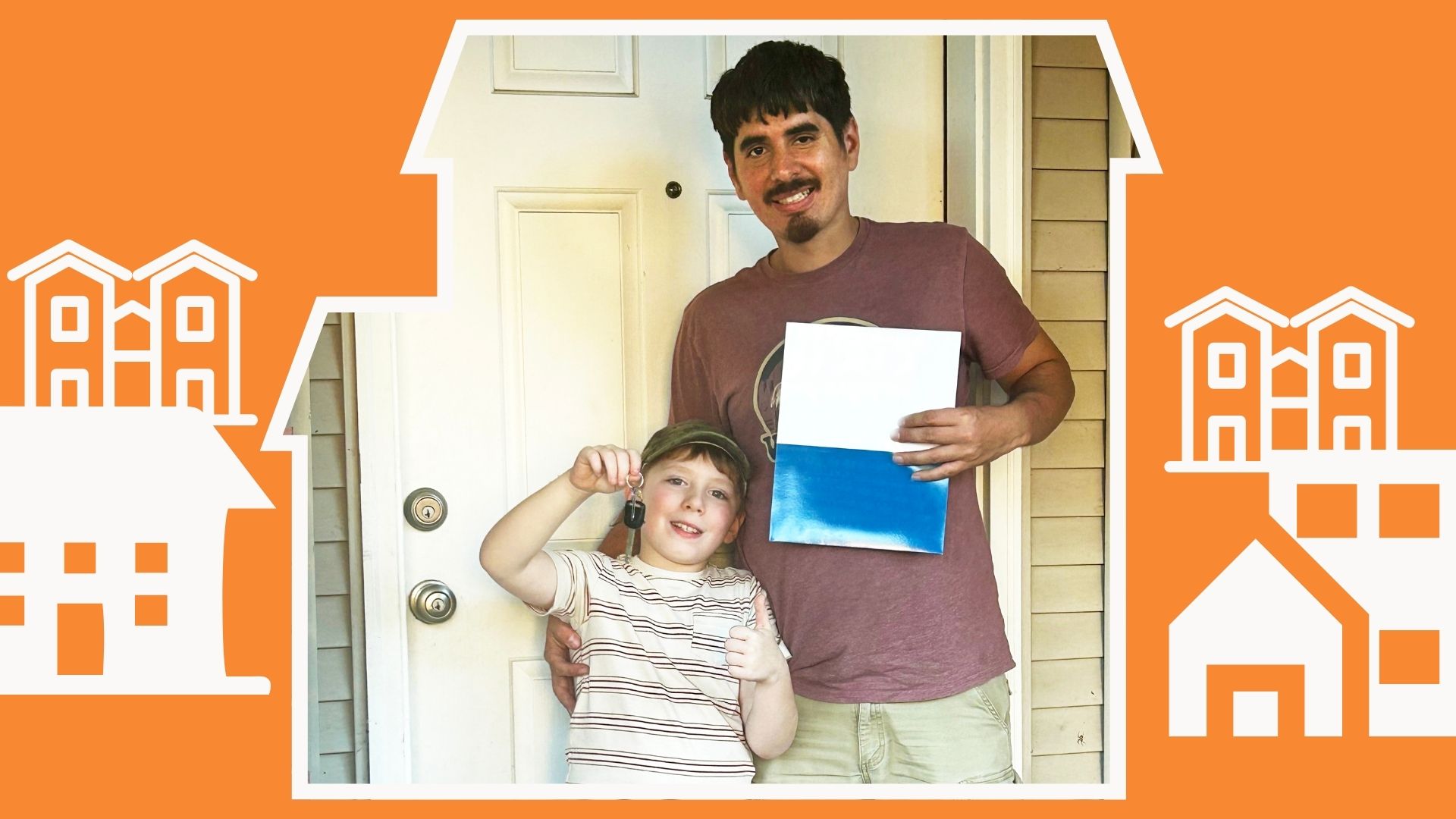 A smiling man with dark hair stands with his son who is holding up the key to their new home