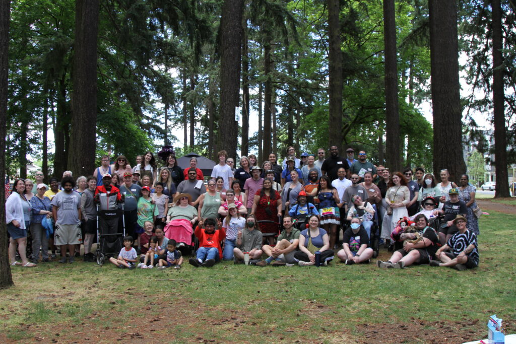 A group photo of about 40 people in a park setting.
